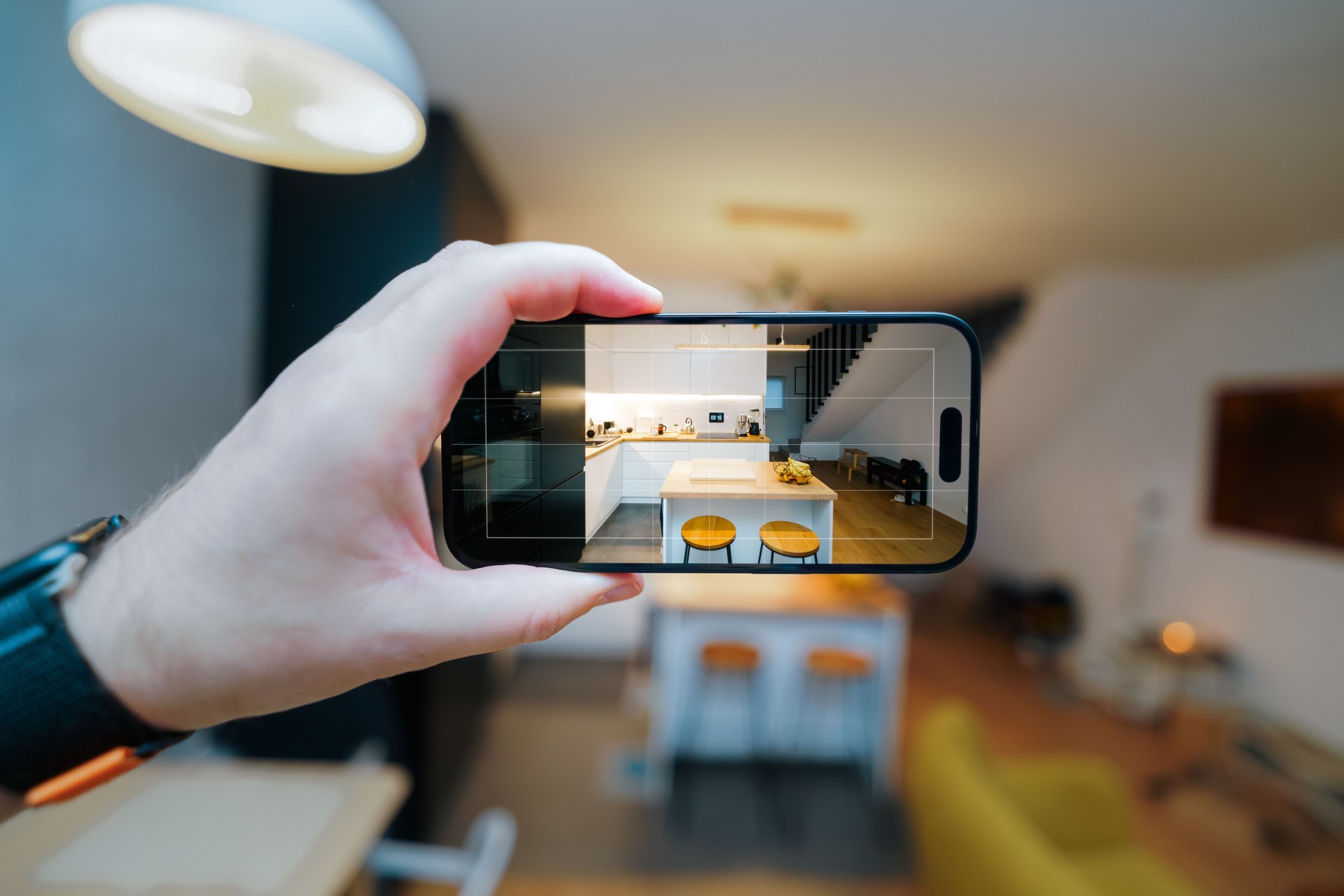 apartment interior real estate app smartphone screen taking photo